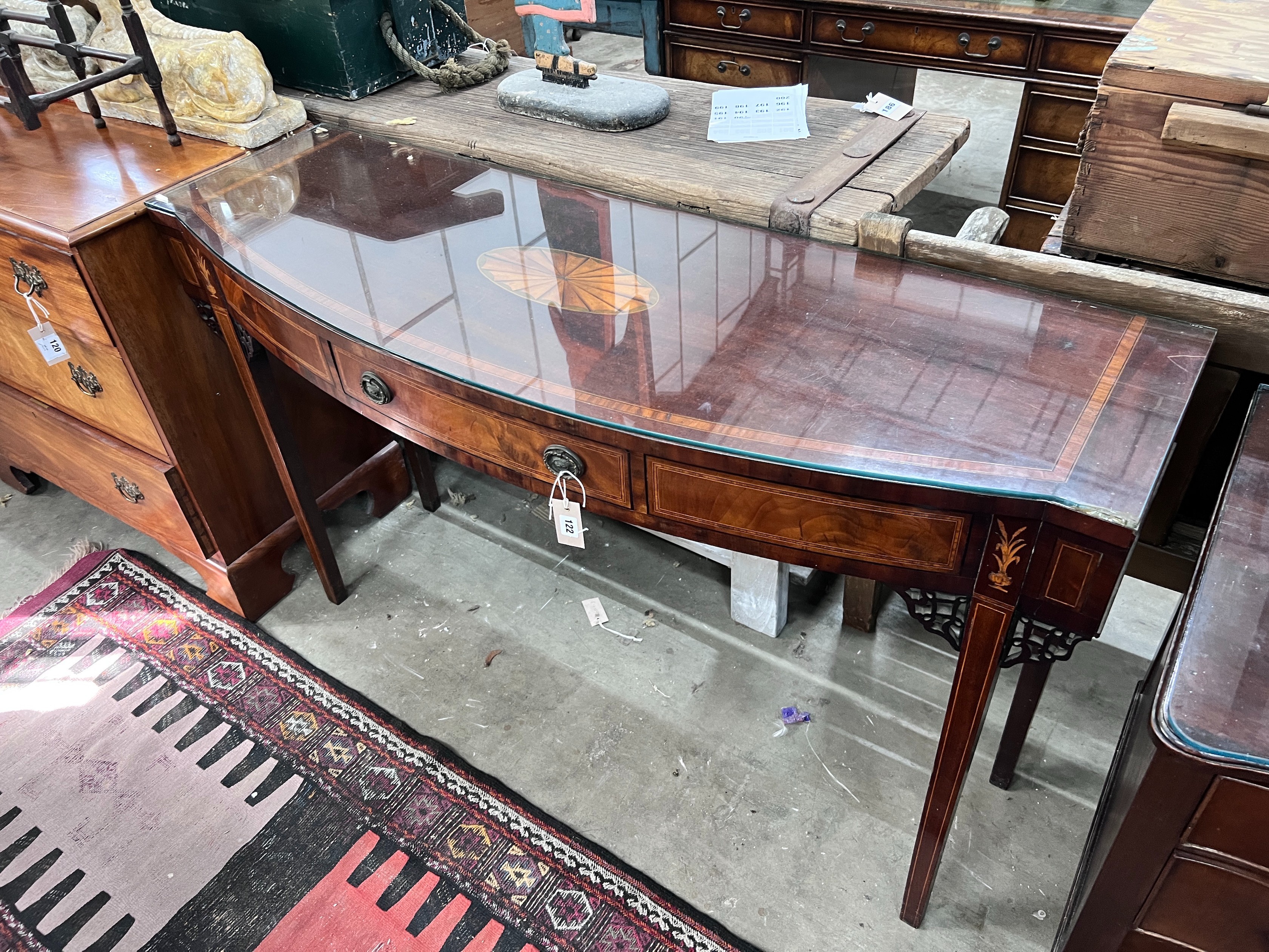 A George III inlaid mahogany bow front serving table, length 140cm, depth 47cm, height 84cm *Please note the sale commences at 9am.